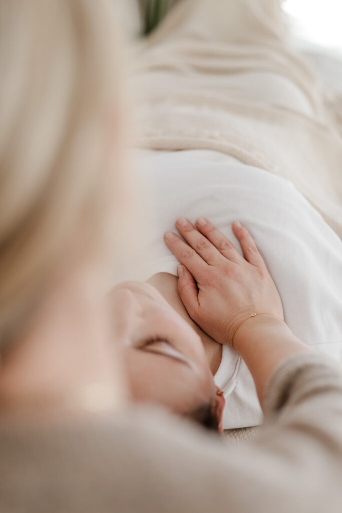 Johanna Habel legt einer Patientin ihre Hand auf der Brust während der Craniosacralen Therapie in ihrer Praxis in Kreuzlingen